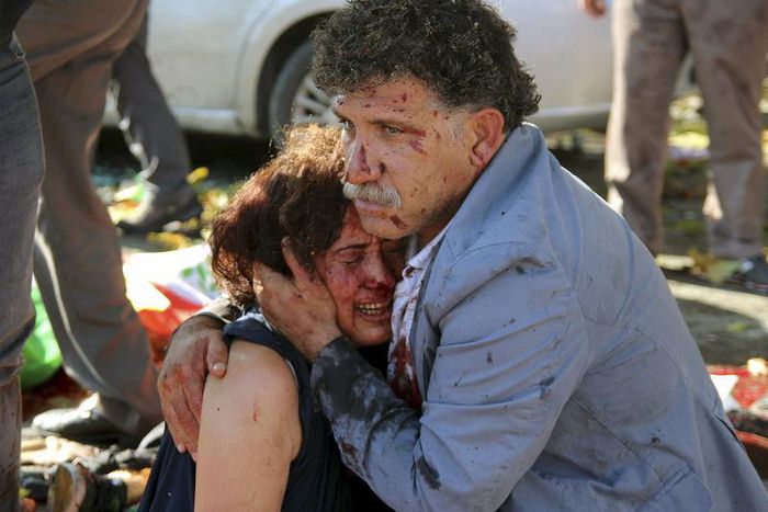 An injured man hugs an injured woman after an explosion during a peace march in Ankara, Turkey, October 10, 2015. REUTERS/Tumay Berkin