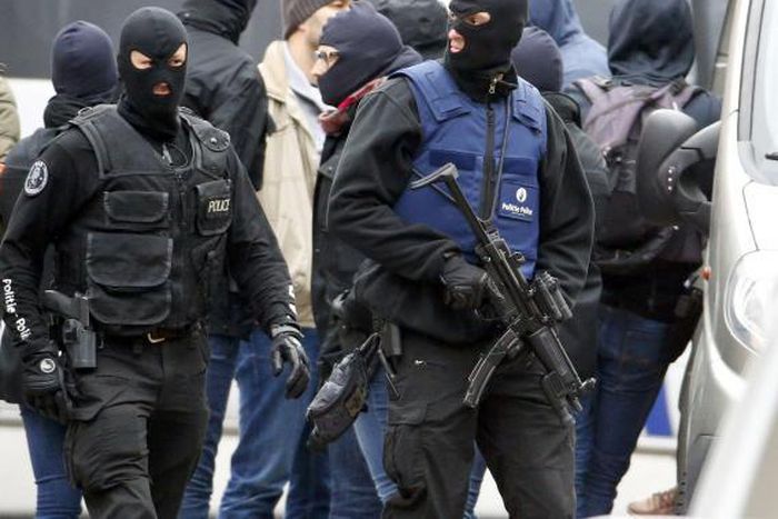 Brussels police surround houses seeking Paris suspects