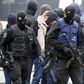 Brussels police surround houses seeking Paris suspects