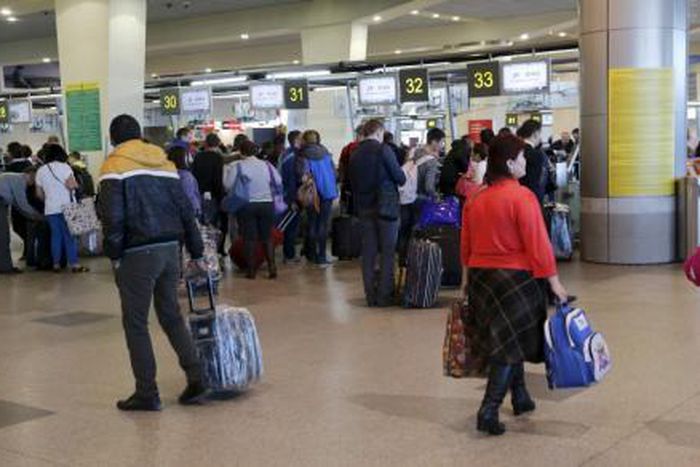 Passengers stand in a line to get registered for the flight ZF 9785 of Azur Air from Domodedovo airport to Sharm al-Sheikh outside Moscow, Russia, November 6, 2015.