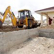 A worker uses heavy machinery to level the ground at the construction site within the Greenpark estate in Lukenya, near Kenya's capital Nairobi, October 31, 2014.  REUTERS/Thomas Mukoya