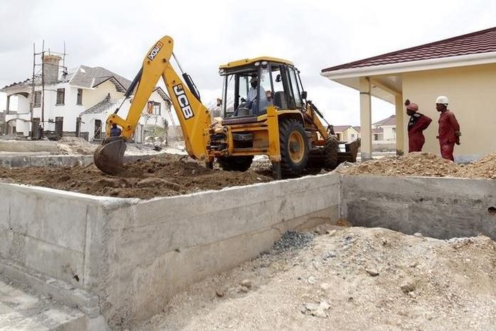 A worker uses heavy machinery to level the ground at the construction site within the Greenpark estate in Lukenya, near Kenya's capital Nairobi, October 31, 2014.  REUTERS/Thomas Mukoya