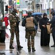 Belgian soldiers and a police officer control the documents of a woman in a shopping street in central Brussels, November 21, 2015, after security was tightened in Belgium following the fatal attacks in Paris.
