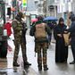 Belgian soldiers and a police officer control the documents of a woman in a shopping street in central Brussels, November 21, 2015, after security was tightened in Belgium following the fatal attacks in Paris.