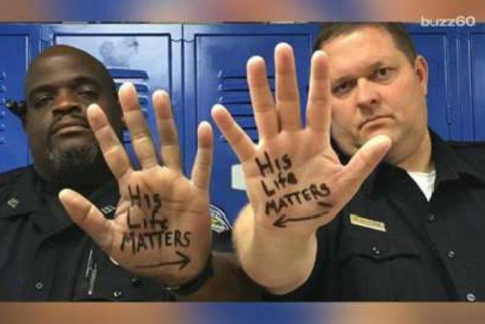 The Trinity Police Department shared a powerful photo of Chief Steven Jones and Officer Donald Givens, who are two different races, with "His Life Matters" written on the palm of their hands, each with an arrow pointed to the other.