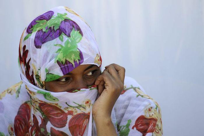 A migrant woman from Somalia covers her face with a scarf at a transit camp in Gevgelija, Macedonia, after entering the country by crossing the border with Greece, September 12, 2015. REUTERS/Ognen Teofilovski