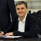 Newly appointed Greek Finance Minister Tsakalotos signs official documents following a swearing-in ceremony at the presidential palace in Athens