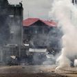 Riot police are seen behind a cloud of tear gas in the Democratic Republic of Congoin a file photo.