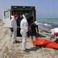 Libyan Red Crescent workers move the body of a dead migrant that was recovered by the Libyan coastguard after a boat sank off the coastal town of Zuwara, west of Tripoli, August 28, 2015. REUTERS/Hani Amara