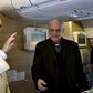 Pope Francis waves to the media aboard the papal plane while en route to Nairobi, Kenya, November 25, 2015. REUTERS/Giuseppe Cacace/pool