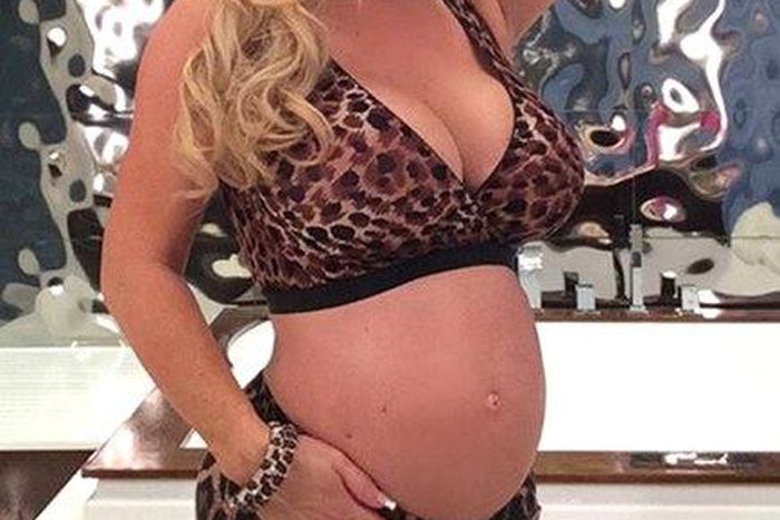 Coco austin shows off baby bump