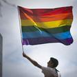 A man waves a rainbow flag while observing a gay pride parade in San Francisco, California June 28, 2015. REUTERS/Elijah Nouvelage