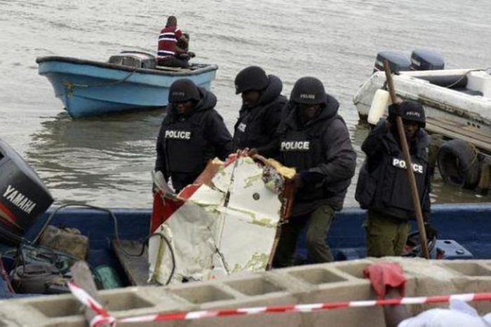 Workers at the scene of a helicopter crash in Oworonshoki, Lagos