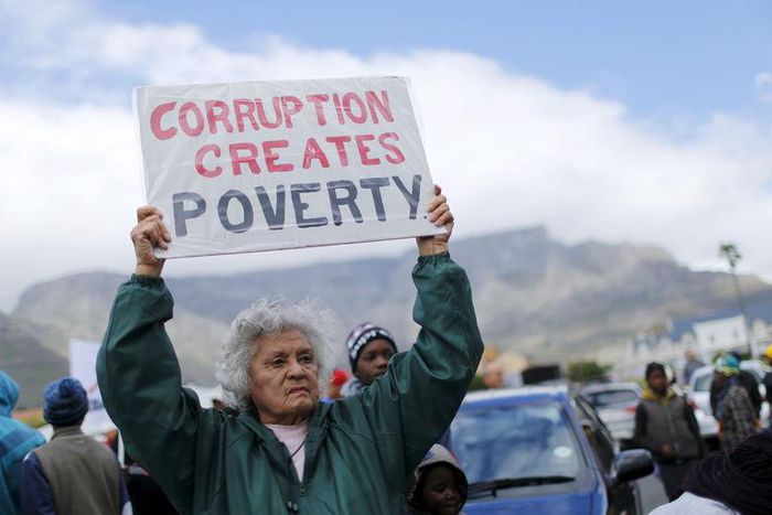 Demonstrators carry placards as they march to protest against corruption in Cape Town, September 30, 2015. REUTERS/Mike Hutchings
