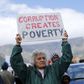 Demonstrators carry placards as they march to protest against corruption in Cape Town, September 30, 2015. REUTERS/Mike Hutchings