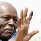 Angola's President Jose Eduardo dos Santos shows off his inked finger to photographers after casting his vote during national elections in the capital Luanda, August 31, 2012. REUTERS/Siphiwe Sibeko