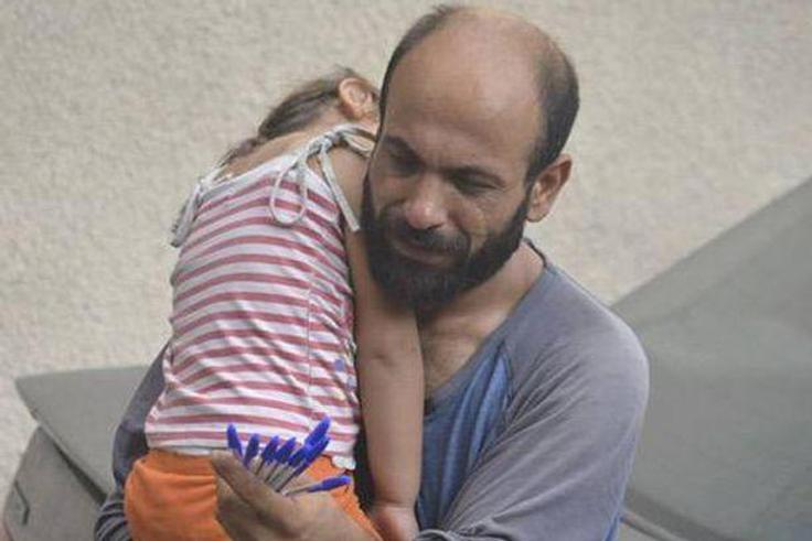 Single parent of two, Abdul and his daughter, Reem, as he hawks pens in Beirut