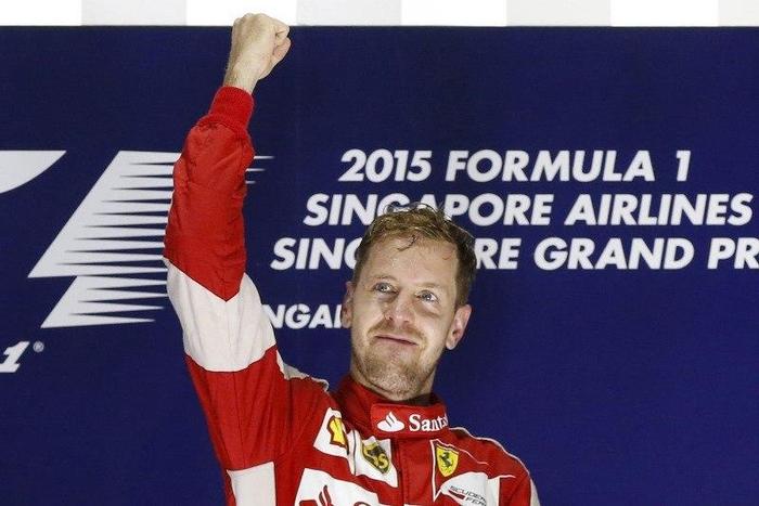Ferrari Formula One driver Sebastian Vettel of Germany celebrates on the podium after winning the Singapore F1 Grand Prix at the Marina Bay street circuit September 20, 2015. REUTERS/Olivia Harris
