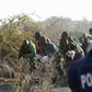 A policeman (R) fires at protesting miners outside a South African mine in Rustenburg, 100 km (62 miles) northwest of Johannesburg, August 16, 2012. REUTERS/Siphiwe Sibeko