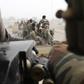 Chadian soldiers drive near the front line during battle against insurgent group Boko Haram in Gambaru, February 26, 2015.   REUTERS/Emmanuel Braun