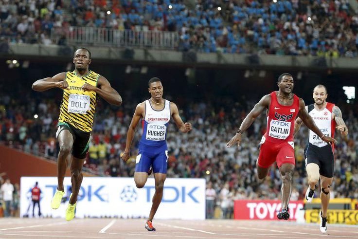 Usain Bolt of Jamaica (L) crosses the finish line ahead of Justin Gatlin (2nd R) from the U.S., Zharnel Hughes of Britain (2nd L) and Ramil Guliyev of Turkey in the men's 200m final during the 15th IAAF World Championships at the National Stadium in Be...