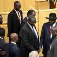 South Sudan's rebel leader Riek Machar (C) shakes hand with South Sudan's President Salva Kiir (black hat) during a peace signing attended by leaders from the region in Ethiopia's capital Addis Ababa, August 17, 2015. REUTERS/Tiksa Negeri
