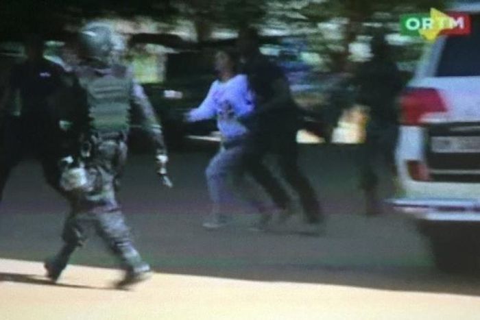 Still image from video show a hostage rushed out from the Radisson hotel in Bamako, Mali, November 20, 2015.  REUTERS/REUTERS TV