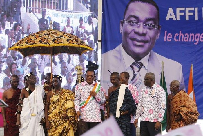 Pascal Affi N'Guessan of the Ivorian Popular Front (FPI) party poses for pictures with chiefs after a ceremony for his official inauguration as a presidential candidate for Ivory Coast's upcoming presidential election, at the Culture Palace of Abidjan ...