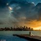 Photographer Sam Yeldham captured the clouds parting for a picture perfect minute behind the happy newlyweds (pictured)