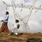 A woman walks her child to school past high voltage electrical pylons on the outskirts of Kenya's capital Nairobi, March 14, 2011.   REUTERS/Thomas Mukoya