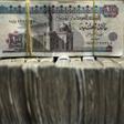 Egypt's pound notes are pictured in stacks of 100 as employees count money at an exchange office in downtown Cairo June 5, 2014.  REUTERS/Amr Abdallah Dalsh
