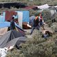 Migrants play paddle ball near tents in the makeshift camp called "The New Jungle" in Calais, France, August 19, 2015. REUTERS/Regis Duvignau