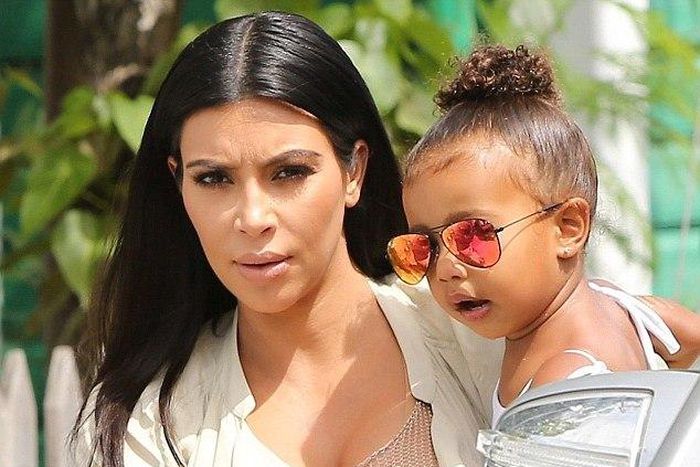 Kim Kardashian carrying her daughter, North West