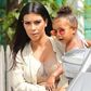 Kim Kardashian carrying her daughter, North West
