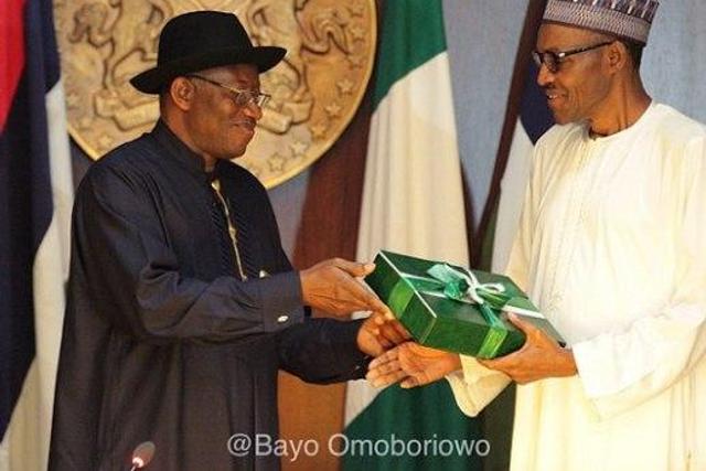 Former President Goodluck Jonathan presenting hand-over documents to President Muhammadu Buhari