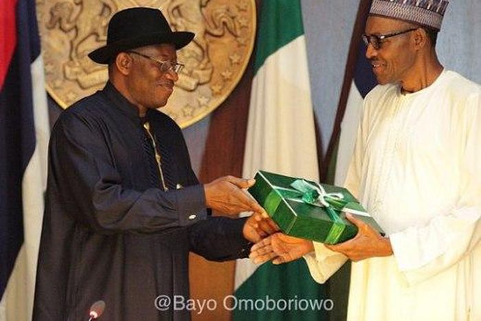 Former President Goodluck Jonathan presenting hand-over documents to President Muhammadu Buhari