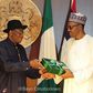 Former President Goodluck Jonathan presenting hand-over documents to President Muhammadu Buhari