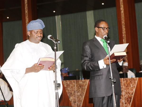 Femi Adesina (left) being sworn in as the President’s Special Adviser on Media and Publicity.