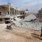 A man drives a motorcycle near a site hit by what residents said were airstrikes carried out by the Russian air force in the town of Darat Izza, in Aleppo province, Syria October 13, 2015.