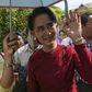 Myanmar pro-democracy leader Aung San Suu Kyi waves at supporters as she visits polling stations at her constituency Kawhmu township November 8, 2015.