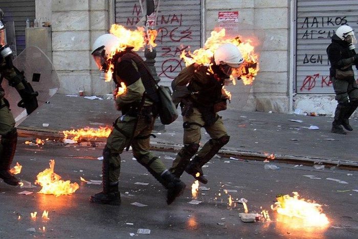 8 Policemen are set ablaze on fire by a petrol bomb thrown by protesters during clashes near the Parliament building in athens, Greece.