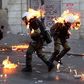 8 Policemen are set ablaze on fire by a petrol bomb thrown by protesters during clashes near the Parliament building in athens, Greece.