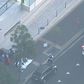 Two people are dead after a lone gunman opened fire outside a police headquarters in Sydney