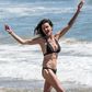 Janice Dickinson rocking a black halter neck bikini, while frolicking at a Malibu Beach