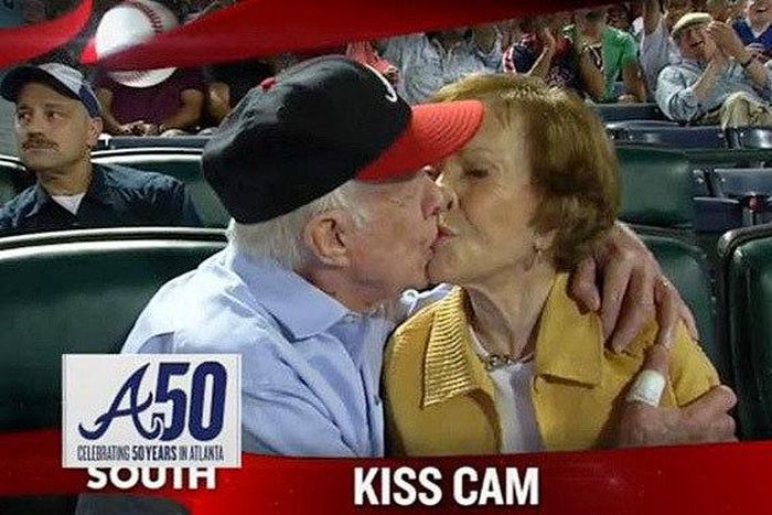 Former President Jimmy Carter kisses his wife Rosalynn on the “Kiss Cam” during a baseball game between the Atlanta Braves and the Toronto Blue Jays on Sept. 17, 2015