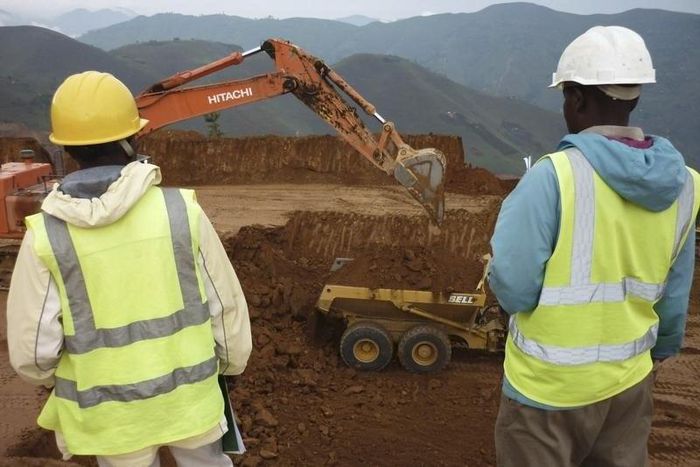 Employees stand in an open pit at Banro's Twangiza mine in eastern Congo, September 28, 2011.   REUTERS/Tom Kirkwood