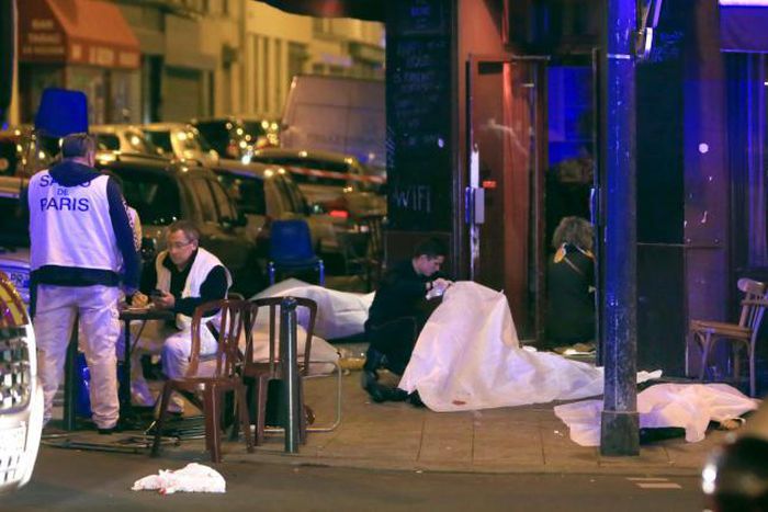  Victims lay on the pavement outside a Paris restaurant, Friday, Nov. 13, 2015. Police officials in France on Friday report multiple terror incidents, leaving many dead. It was unclear at this stage if the events are linked.