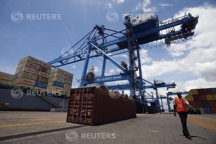 A worker walks by a crane at the main port in the Kenyan coastal city of Mombasa March 7, 2013.    REUTERS/Marko Djurica