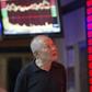 An investor walks past an electronic board showing stock information at a brokerage house in Nanjing, Jiangsu province, China, September 22, 2015. REUTERS/Stringer