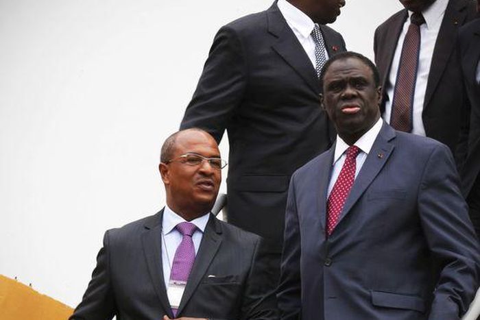 Burkina Faso interim President Michel Kafando (R) arrives with Azito Energie Managing Director Luc Aye (L) for a visit to the Azito power plant in Yopougon, Abidjan, Ivory Coast. REUTERS/Thierry Gouegnon